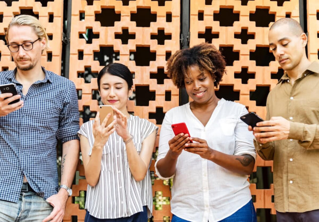 Standing people using phones