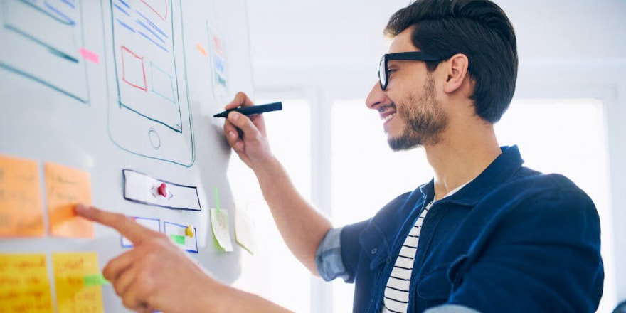 UX Designer writing on a whiteboard