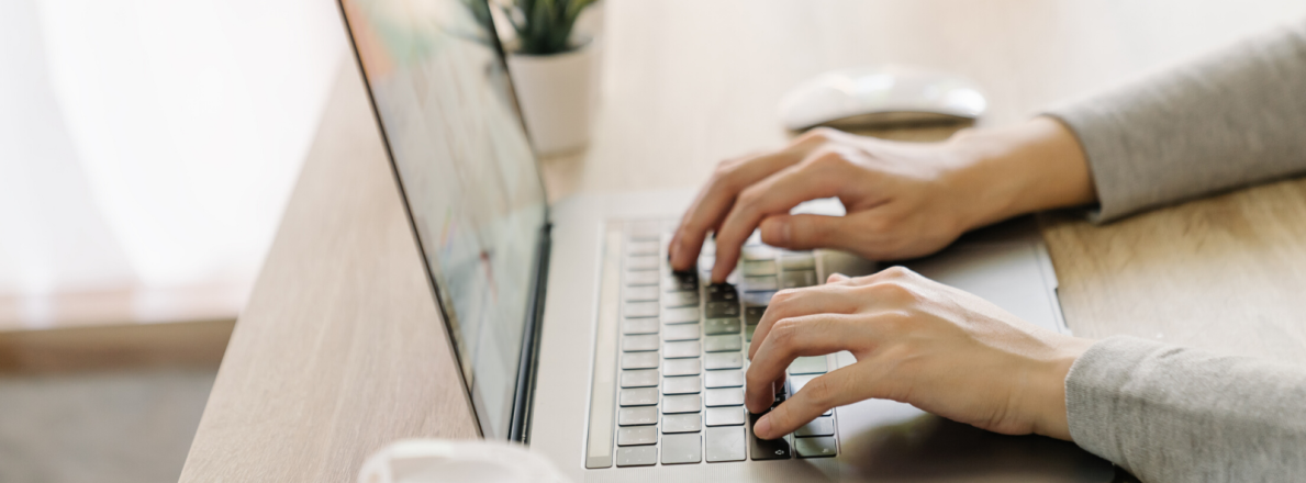 Person writing on laptop