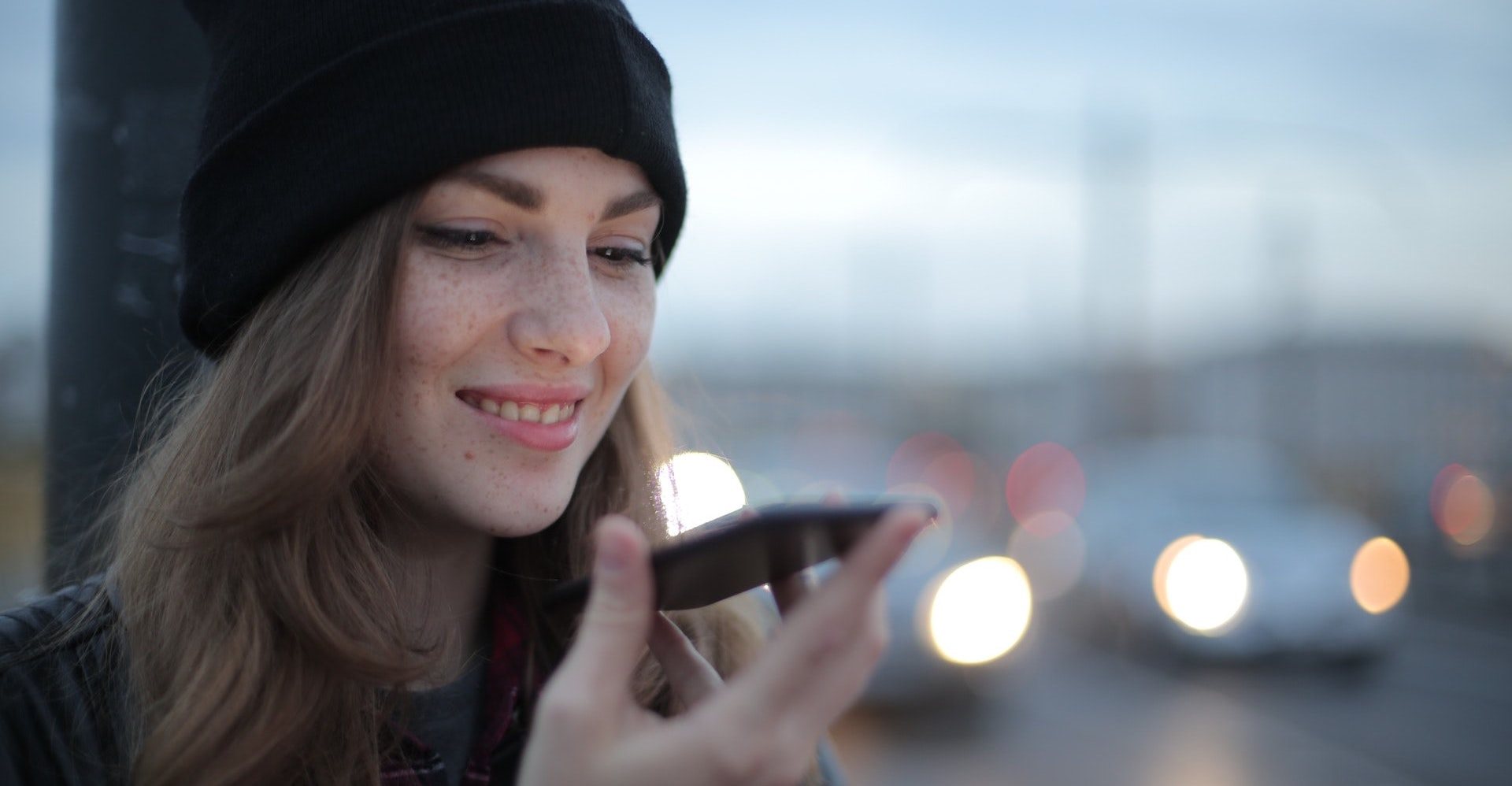 Young woman using voice search on her smartphone